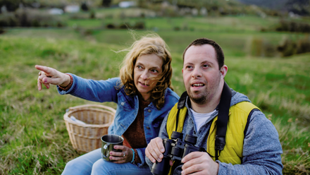 Woman and disabled man with binoculars outdoors - lo.png