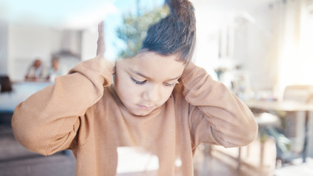 Distressed child with hands over ears.jpg