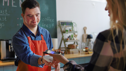 Young disabled man working in a cafe lo.png