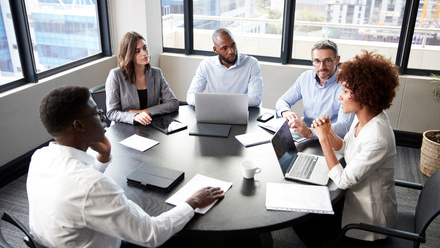 Small group of people round a meeting table.jpg