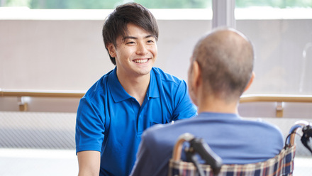 Man in wheelchair with care worker.jpg