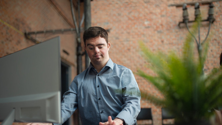 Young man with down syndrome using computer .jpg