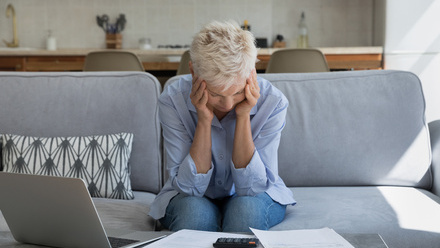 Woman with head in hands working on finances.jpg