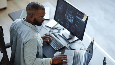 Man at work with two computers.jpg